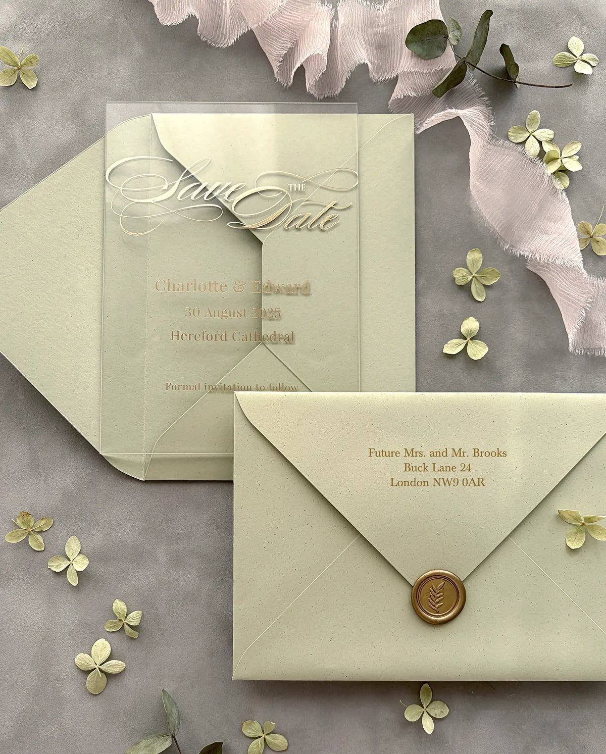 Acrylic Save the Date card with gold foil names and white script lettering, sage green envelope with gold foil guest addressing and gold wax seal — Polina Perri