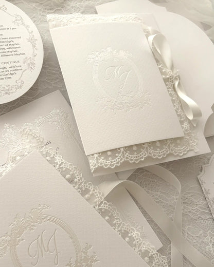 Alyson Lace White luxury invitation suite with soft grey-beige digitally printed frame on designer paper, optional oval details and shaped RSVP cards, paired with designer textured envelope featuring shaped flap — Polina Perri. 