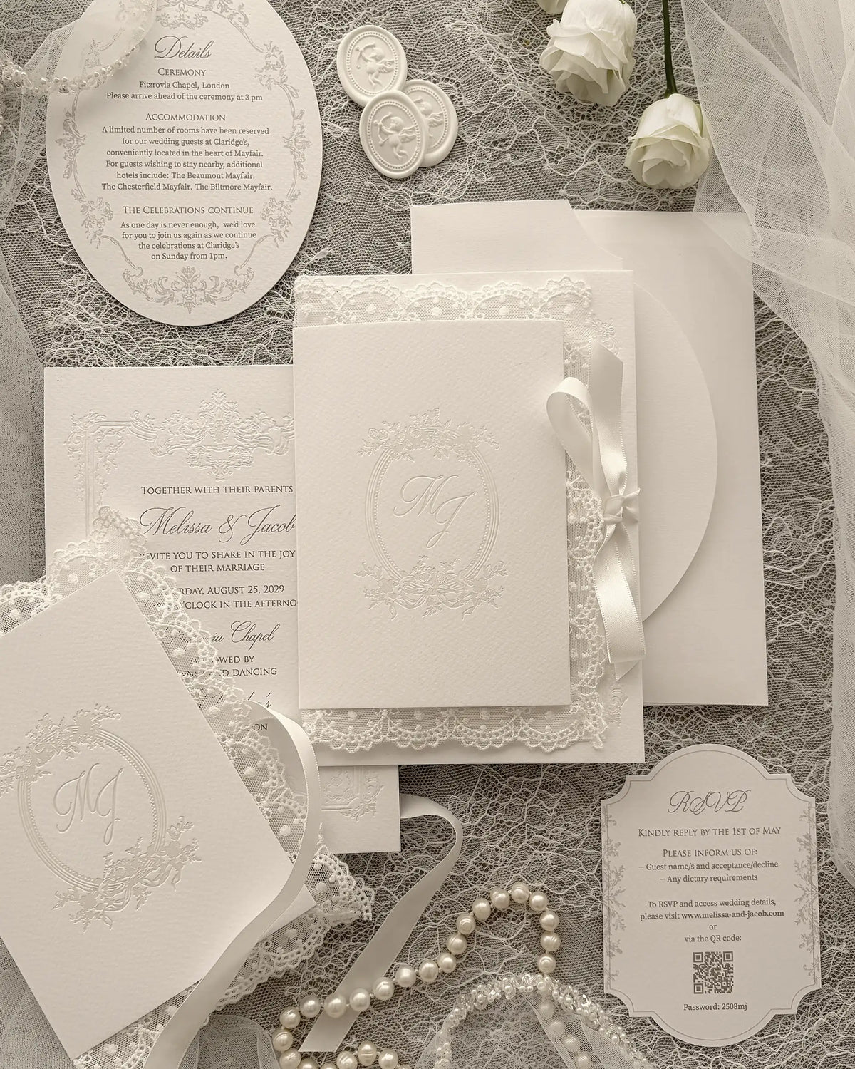Alyson Lace White wedding invitation with pearl foil-pressed monogram in delicate lace folder, finished with satin ribbon and vintage pearl frame design — Polina Perri. 