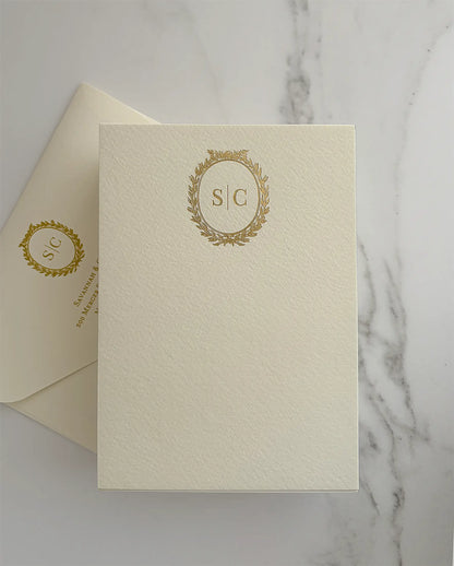 Cream A6 thank you card with a gold foil laurel wreath monogram and a matching envelope with foil monogram and return address — Polina Perri