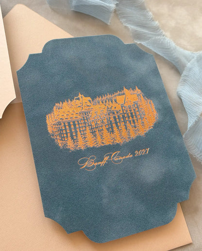 Venue Velvet Save the Date dusty blue velvet side with copper foil illustration of Fairmont Banff Springs on cream envelope — Polina Perri